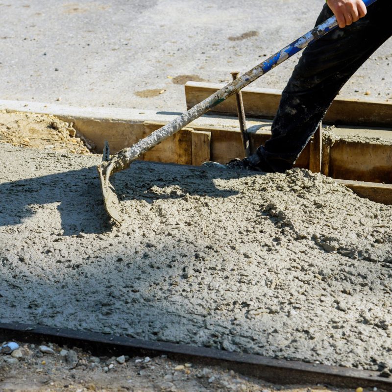 Cement of sidewalk a new building under construction Cement of sidewalk a new building under construction